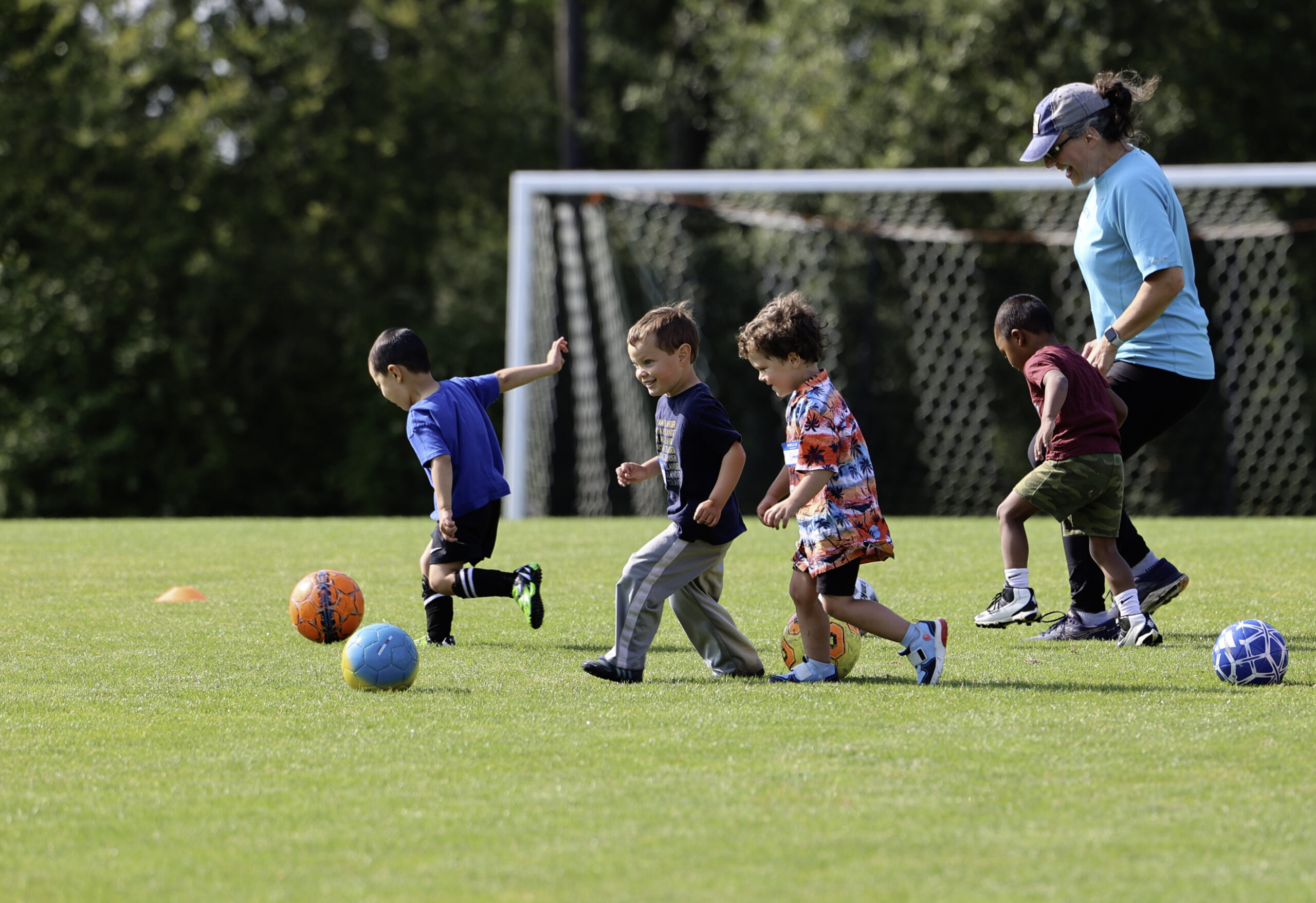 Preschoolers playing soccer together. Text: Registration opens online April 28 at 7am.