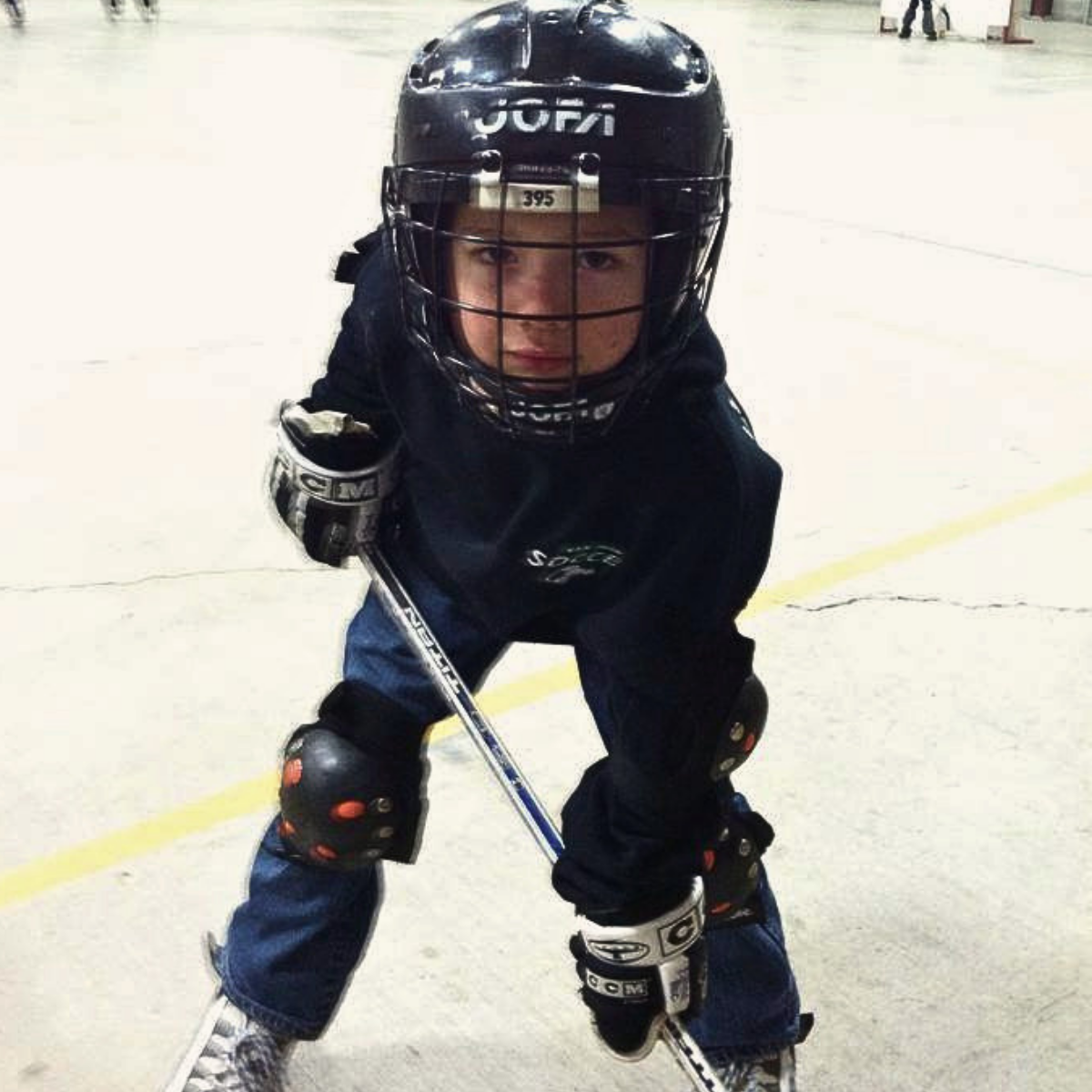 kid playing roller hockey