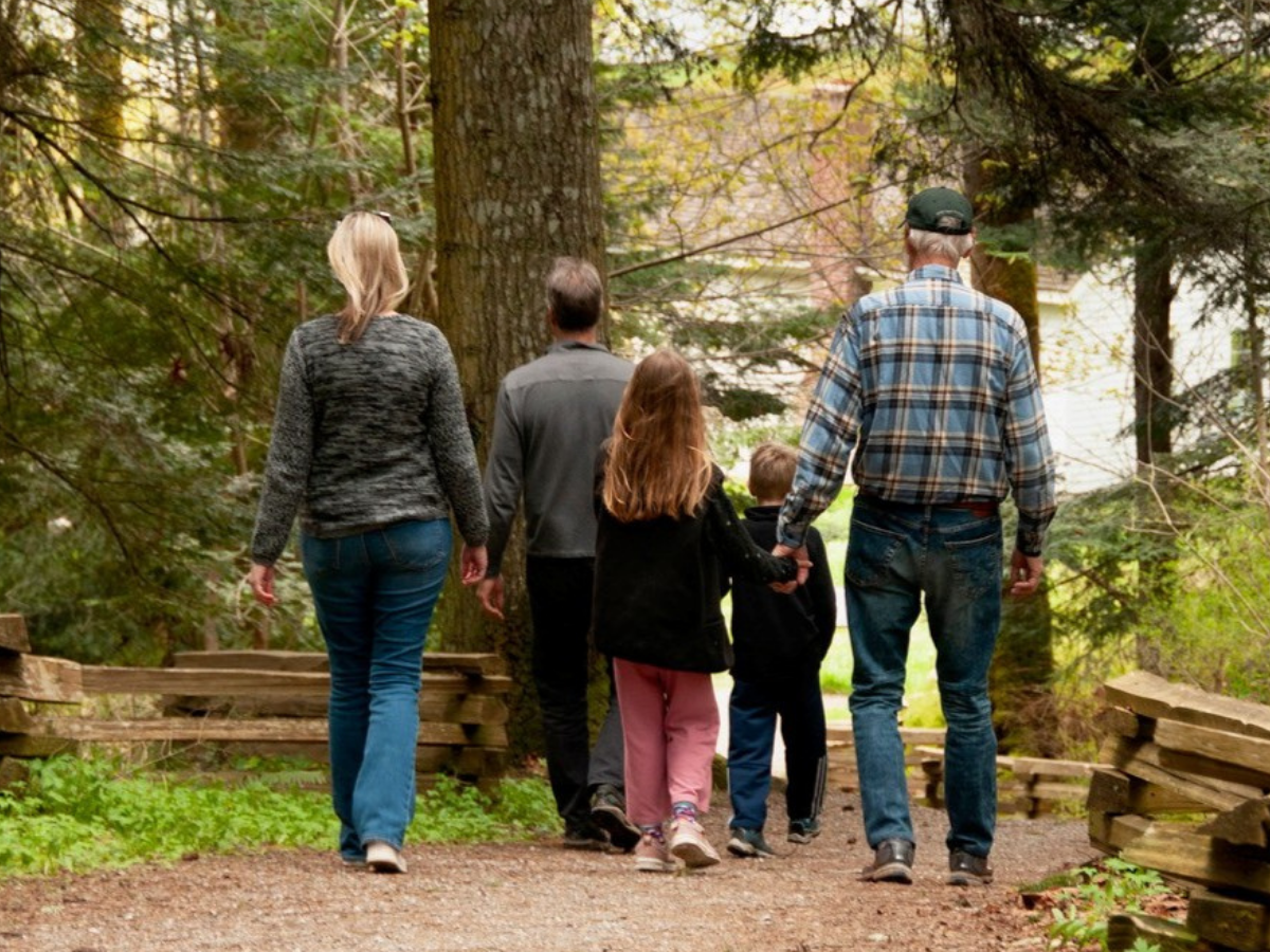 group of people birdwatching in a field
